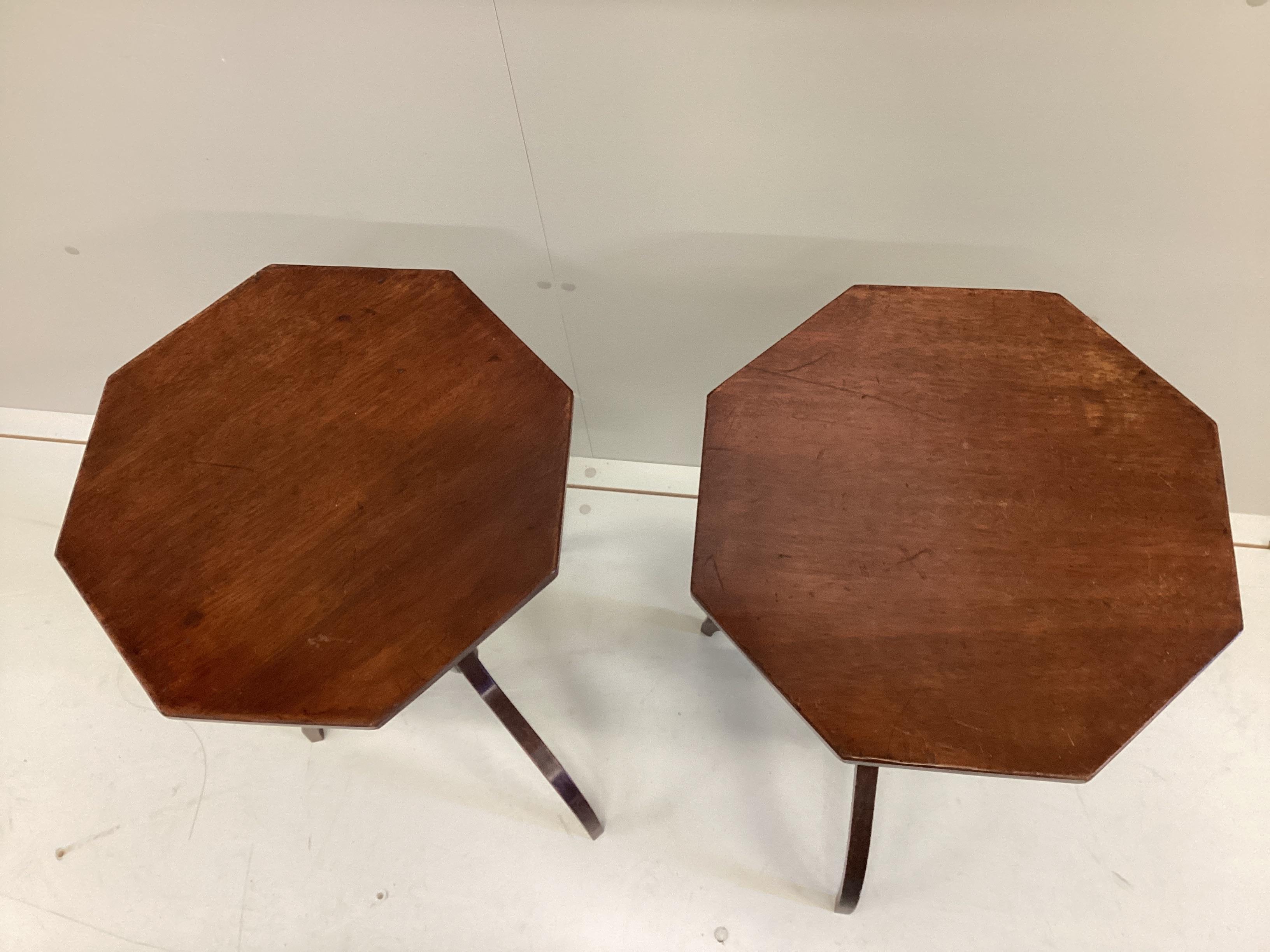 A pair of Regency style octagonal mahogany tripod wine tables, width 40cm, height 72cm